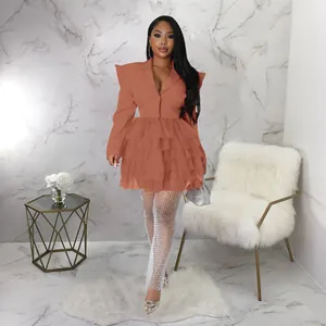 Elegant rust red plus size tiered cake blazer dress shown in a luxury interior setting