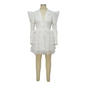 Detail view of a white tiered ruffle mini dress with pointed shoulders on mannequin