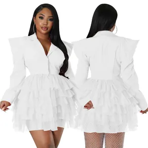 Detailed view of white blazer dress featuring exaggerated shoulders and tiered tulle skirt