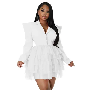 Detail view of a stylish white blazer dress featuring a tiered tulle ruffled cake skirt