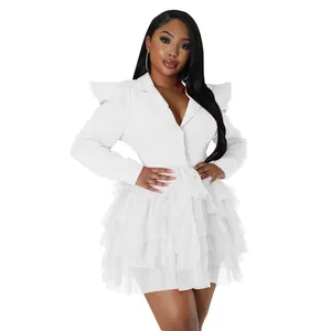 Close-up detail of a white blazer mini dress with a layered tulle cake skirt and puff sleeves
