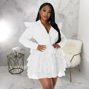 Detailed view of white long sleeve blazer dress with a layered ruffled cake skirt style