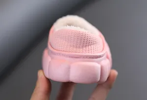 Dettaglio di pantofole di peluche rosa per bambini con tallone e fodera calda