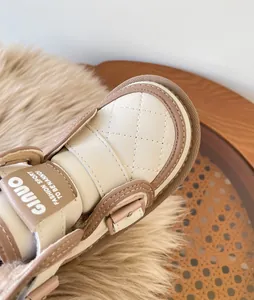 Close-up detail of baby winter snow boots with warm plush lining and quilted texture.