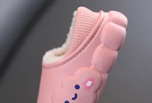 Dettaglio di pantofole rosa per bambini con calda fodera in pile e motivo a nuvola