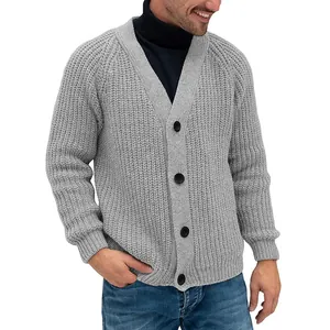 Close-up detail of a grey chunky knit men's cardigan featuring large black buttons.