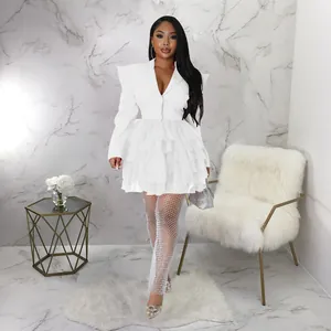 Detailed view of an elegant white tiered ruffle cake dress with structured shoulders