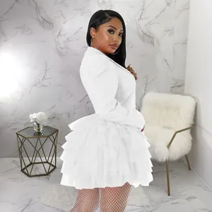 Close-up view of the tiered ruffle detail on this elegant white blazer cake dress