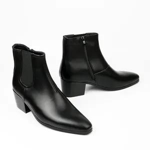 Detailed view of men's black leather Chelsea boots with block heel and side zipper.