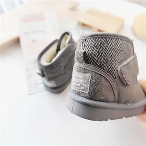 Detail view of children's grey snow boots with warm fleece lining and heel patch