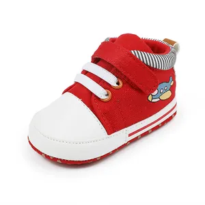 Detailaufnahme eines rot-weißen Babylauflernschuhs mit einem süßen Cartoon-Flugzeug-Patch