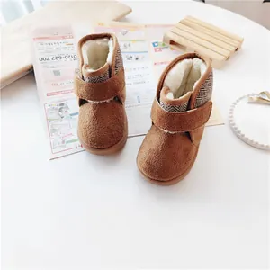 Detailed view of warm brown children's snow boots with faux fur lining and velcro straps