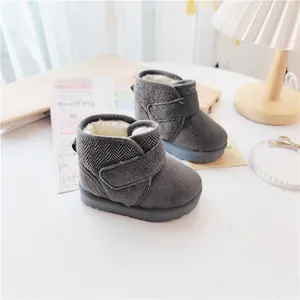 Side view of grey children's snow boots with warm faux fur lining and velcro strap