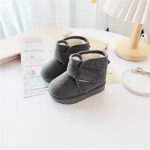 Close-up of grey toddler winter snow boots featuring warm fleece lining and Velcro strap