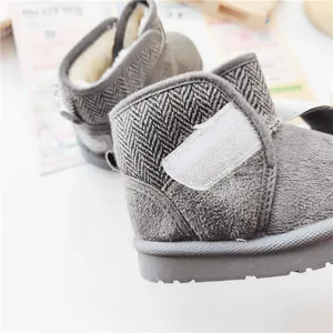 Close-up of grey herringbone winter snow boots for kids with warm plush lining and velcro
