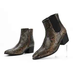 Close-up view of men's square-toe Chelsea boots with snakeskin pattern and high heel.
