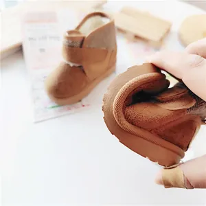 Close-up of flexible sole on brown children's winter snow boots with warm lining