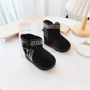 Close-up of black children's winter snow boots with warm faux fur lining and toggle button