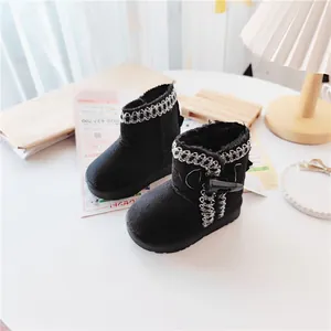 Close-up of cozy black children's snow boots with toggle button and fleece lining