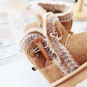 Close-up of warm winter snow boots for children with cozy faux fur and toggle closure