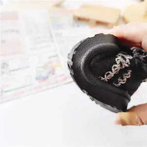 Close-up showing the flexible and soft sole of the children's winter snow boots.