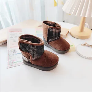 Warm brown children's winter snow boots featuring soft fleece lining and plaid detail