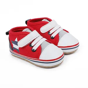 Vista detallada de zapatos de bebé rojos y blancos con motivo de estrella y velcro