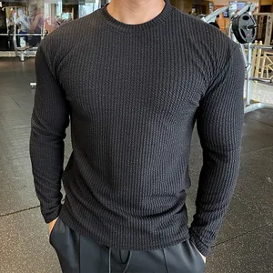 Detailed view of black men's long sleeve knit sweater showing high-quality textured fabric