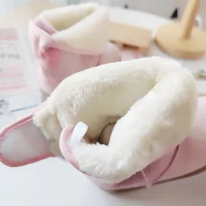 Detail view of the plush thick white faux fur lining inside pink kids' winter snow boots.