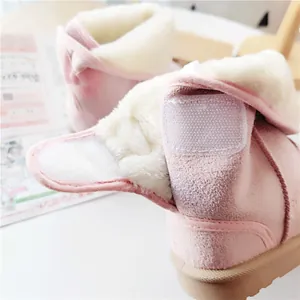 Close-up of pink toddler snow boot with thick faux fur lining and Velcro strap closure.