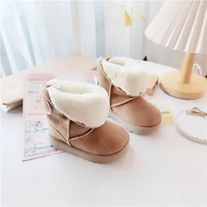 Detailed view of children's warm winter snow boots with thick white faux fur lining