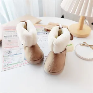 Cozy brown kids' snow boots with thick faux shearling lining in soft room setting