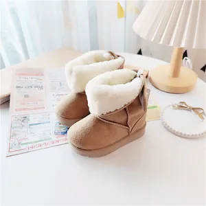 Cozy toddler winter snow boots with thick white faux fur lining in camel brown suede