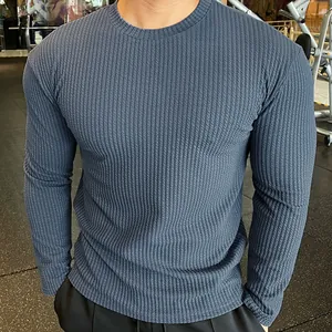 Detailed view of men's slim fit blue knitted long-sleeved sweater with vertical texture