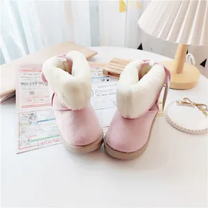 Detailed view of pink children's snow boots with thick white faux fur lining