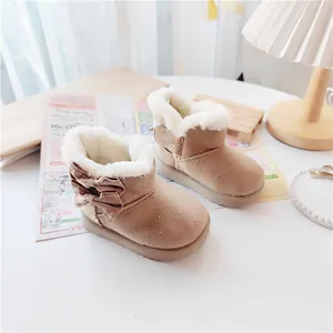 Cozy beige children's snow boots with plush faux fur lining and a side bow detail.