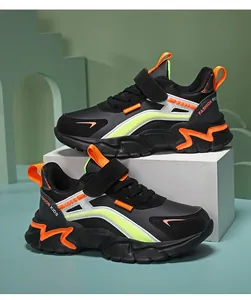 Detailed side view of black children's running shoes with orange and neon yellow accents.
