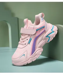 Detailed side view of pink girls sneakers with purple accents and easy velcro strap