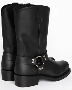Detail view of black leather harness motorcycle boots with metal ring and studs