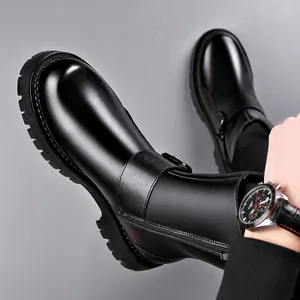 Stylish men's black leather Chelsea boots with thick sole and side zipper detail.