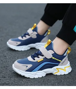 Detailed side view of children's blue and white lightweight running shoes worn outdoors