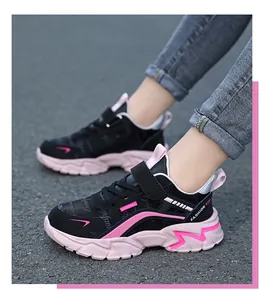 Close-up action shot of children's pink and black sneakers for girls running outdoors