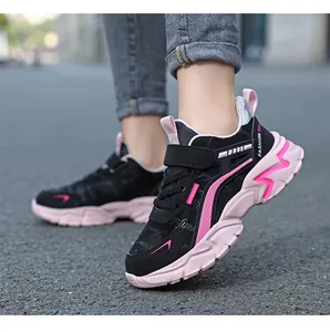 Detail of pink and black girls sports shoes with Velcro strap for outdoor running