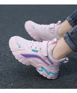 Side view of pink girls sports sneakers featuring chunky soles and velcro strap design