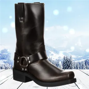 Classic dark brown leather harness boot with metal ring strap detail in snow scene