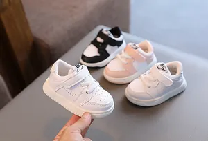 Macro view of toddlers' walking shoes featuring soft soles and breathable design.