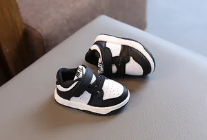 Close-up detail of black and white baby walking shoes featuring soft non-slip soles