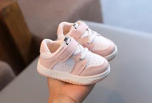 Close-up of pink and white toddler sneakers with soft non-slip sole and strap detail