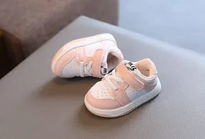 Stylish pink and white baby walking sneakers with convenient velcro straps for toddlers