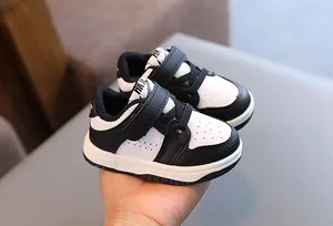 Close-up of black and white toddler sneakers with velcro straps for baby first walkers